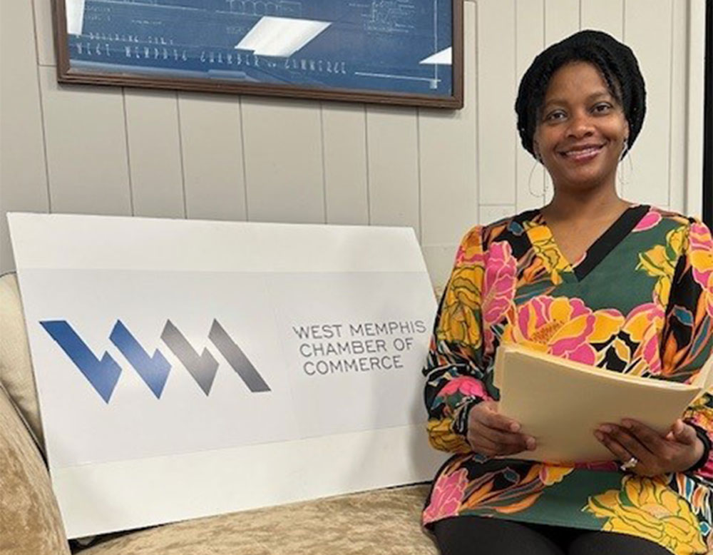 抖阴短视频 professor Dr. Kimberly Wolfe poses with West Memphis Chamber of Commerce signage after being elected to board of directors.